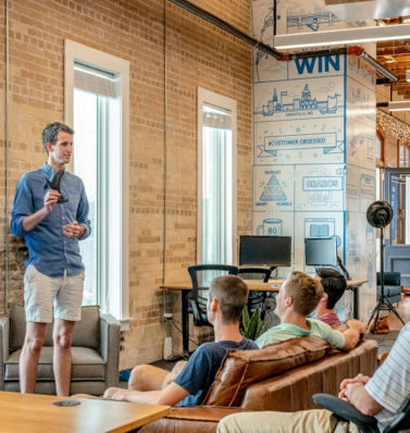 man standing in front of group of men